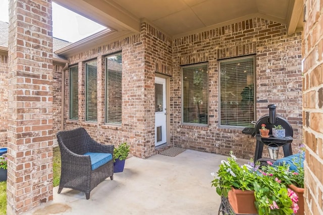 7901 Sunrise Ravine Pass, Lago Vista, TX 78645 - property entrance featuring brick siding and a patio area