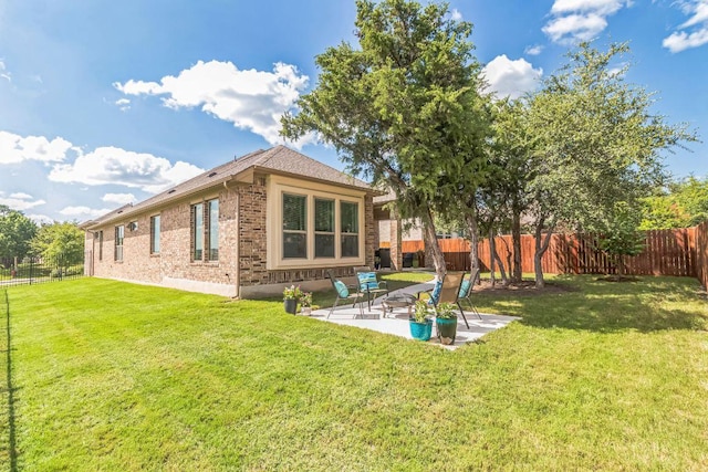 7901 Sunrise Ravine Pass, Lago Vista, TX 78645 - rear view of property with brick siding, a fenced backyard, and a patio area
