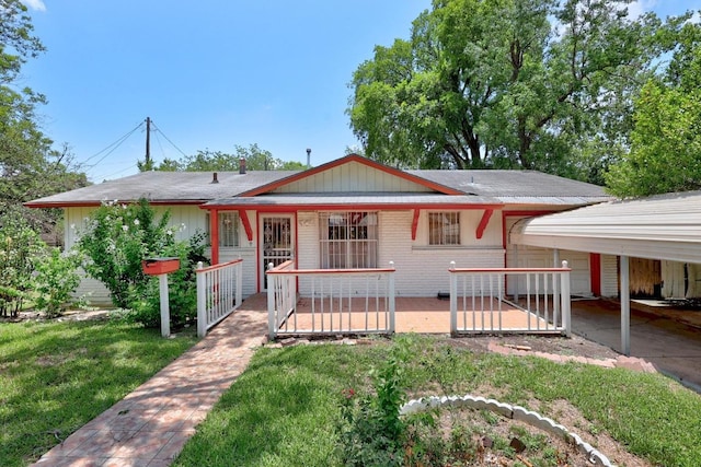 4705 Enchanted Ln, Austin, TX 78745 - view of front facade with a front yard, covered porch, and a carport