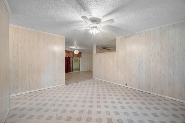 4705 Enchanted Ln, Austin, TX 78745 - empty room with a ceiling fan, wood walls, a textured ceiling, and ornamental molding