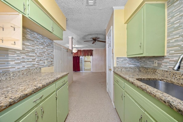 4705 Enchanted Ln, Austin, TX 78745 - kitchen featuring a ceiling fan, a textured ceiling, light countertops, and tasteful backsplash