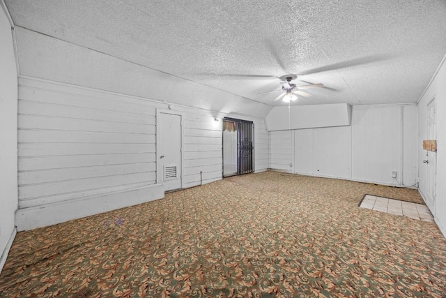 4705 Enchanted Ln, Austin, TX 78745 - carpeted empty room with ceiling fan, a textured ceiling, and lofted ceiling