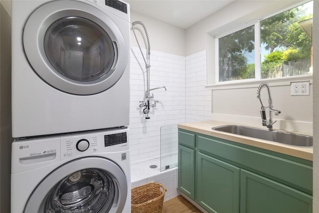 2119 Rabb Rd, Austin, TX 78704 - laundry area featuring stacked washer and clothes dryer and cabinet space