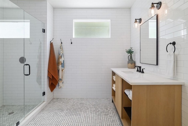 2119 Rabb Rd, Austin, TX 78704 - bathroom with vanity, plenty of natural light, tile walls, a stall shower, and tile patterned floors