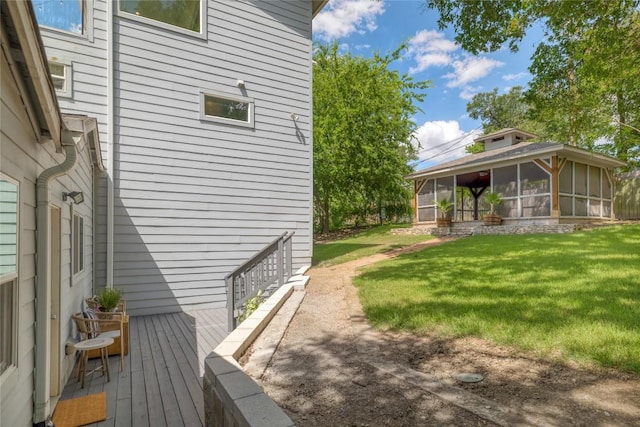 2119 Rabb Rd, Austin, TX 78704 - view of side of property with a sunroom, a lawn, and a wooden deck