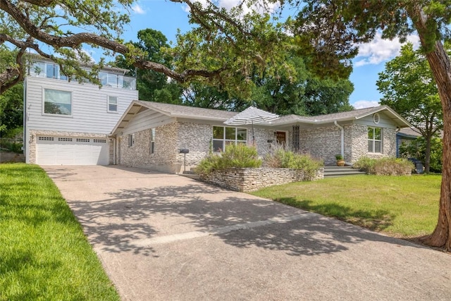 2119 Rabb Rd, Austin, TX 78704 - view of front of property featuring a front yard, driveway, a garage, and brick siding