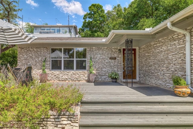 2119 Rabb Rd, Austin, TX 78704 - doorway to property featuring stone siding and a deck