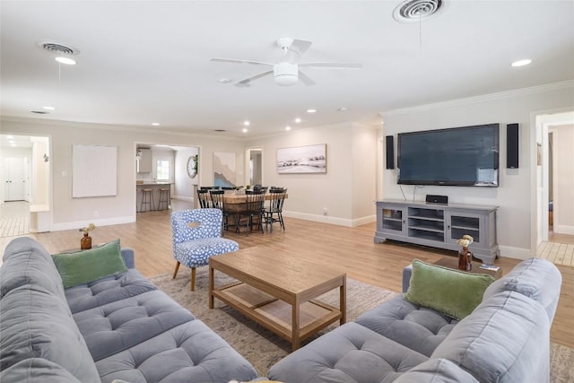 2119 Rabb Rd, Austin, TX 78704 - living room featuring light wood-type flooring, ornamental molding, a ceiling fan, and recessed lighting