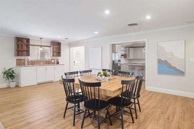 2119 Rabb Rd, Austin, TX 78704 - dining space featuring ornamental molding, light wood finished floors, and recessed lighting