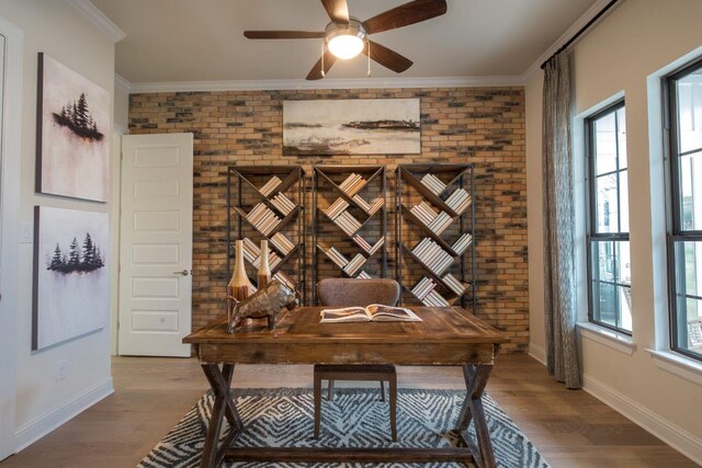 106 Double Eagle Ranch Dr, Cedar Creek, TX 78612 - home office with brick wall, a ceiling fan, wood finished floors, and ornamental molding