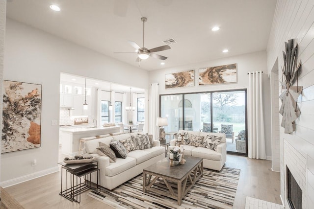 106 Double Eagle Ranch Dr, Cedar Creek, TX 78612 - living area with light wood finished floors, a ceiling fan, recessed lighting, healthy amount of natural light, and a high ceiling