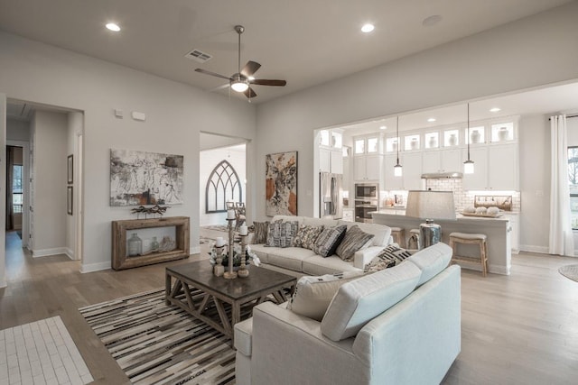 106 Double Eagle Ranch Dr, Cedar Creek, TX 78612 - living room with a ceiling fan, light wood finished floors, and recessed lighting