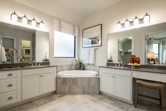 106 Double Eagle Ranch Dr, Cedar Creek, TX 78612 - bathroom featuring two vanities, a bath, and lofted ceiling