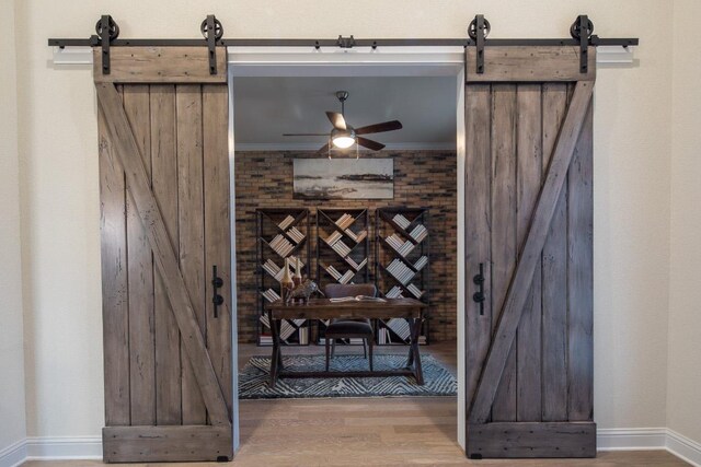 106 Double Eagle Ranch Dr, Cedar Creek, TX 78612 - wine cellar featuring a barn door, wood finished floors, and ceiling fan