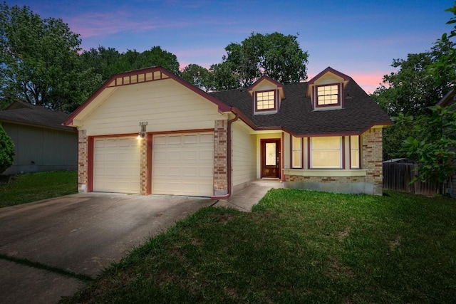 2810 Goldbridge Dr, Austin, TX 78745 - view of front of house with a garage, concrete driveway, a yard, roof with shingles, and brick siding
