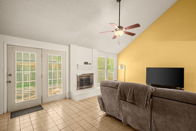 2810 Goldbridge Dr, Austin, TX 78745 - living area with a ceiling fan, a brick fireplace, healthy amount of natural light, lofted ceiling, and light tile patterned floors