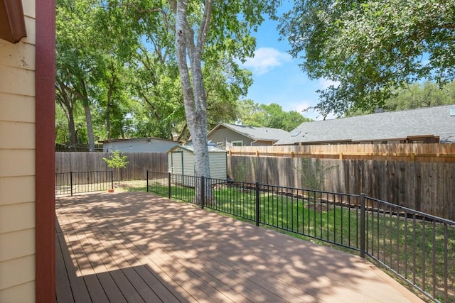 2810 Goldbridge Dr, Austin, TX 78745 - wooden deck with a fenced backyard and a storage unit