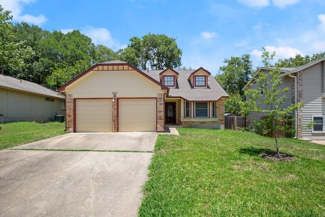 2810 Goldbridge Dr, Austin, TX 78745 - view of front facade with brick siding, concrete driveway, a front yard, and a garage