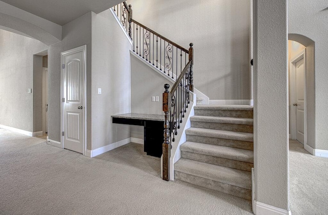5821 Viejo Dr, Austin, TX 78738 - staircase with arched walkways and carpet floors