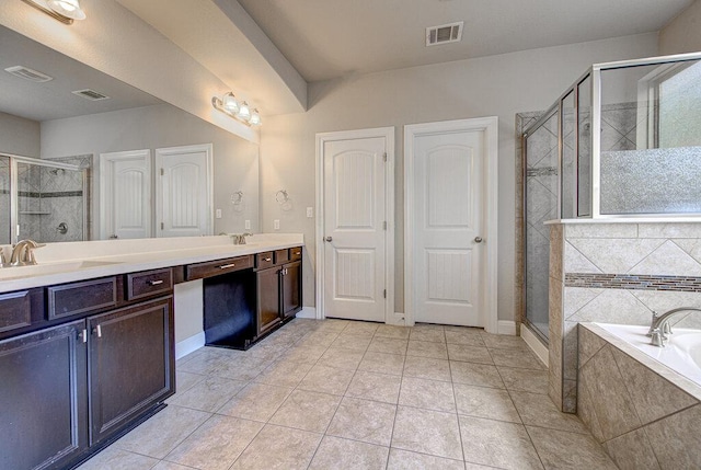 5821 Viejo Dr, Austin, TX 78738 - full bathroom with double vanity, a garden tub, a stall shower, and tile patterned flooring