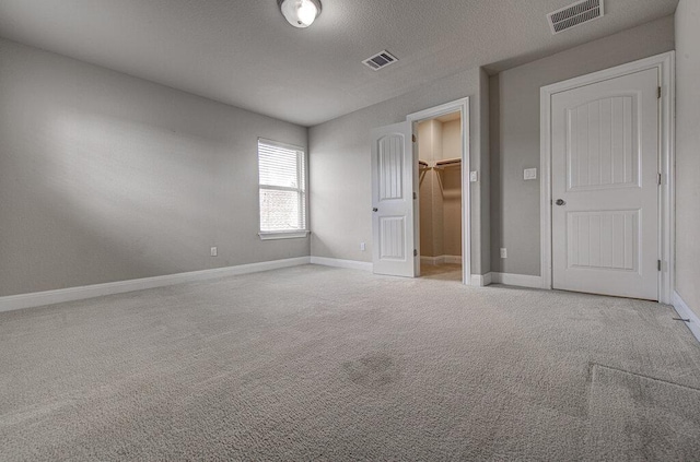 5821 Viejo Dr, Austin, TX 78738 - unfurnished bedroom with carpet, a walk in closet, and a closet