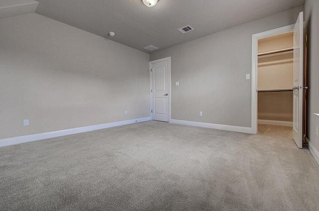 5821 Viejo Dr, Austin, TX 78738 - unfurnished bedroom featuring a walk in closet, carpet floors, a closet, and lofted ceiling