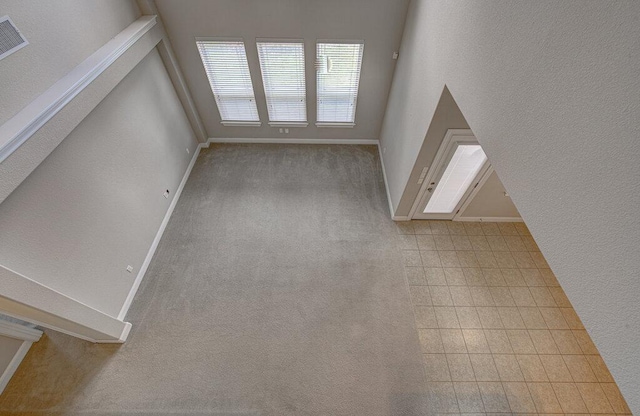5821 Viejo Dr, Austin, TX 78738 - unfurnished living room featuring baseboards and carpet