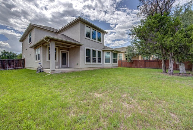 5821 Viejo Dr, Austin, TX 78738 - back of property with a fenced backyard, stucco siding, and a patio