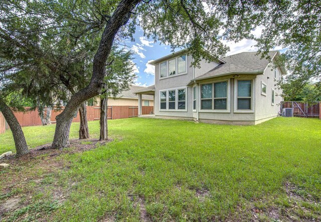 5821 Viejo Dr, Austin, TX 78738 - rear view of house with a fenced backyard, a shingled roof, and stucco siding
