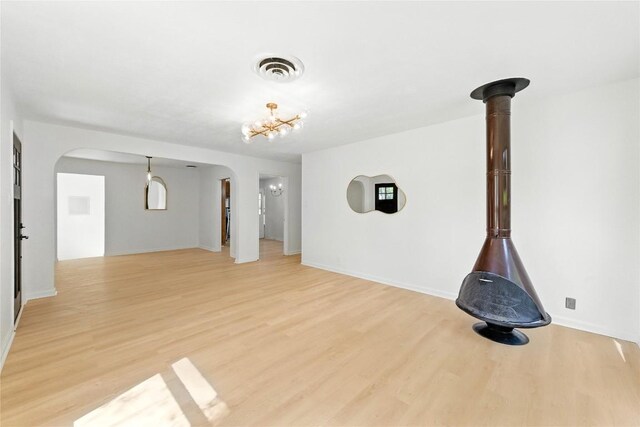 1302 S 2nd St, Killeen, TX 76541 - unfurnished living room with arched walkways and light wood-style flooring