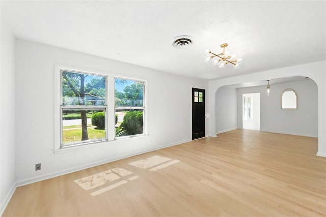 1302 S 2nd St, Killeen, TX 76541 - unfurnished living room with arched walkways and light wood finished floors