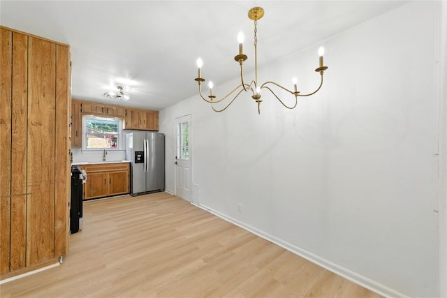 1302 S 2nd St, Killeen, TX 76541 - kitchen featuring stainless steel fridge with ice dispenser, light wood-type flooring, range, a chandelier, and brown cabinetry
