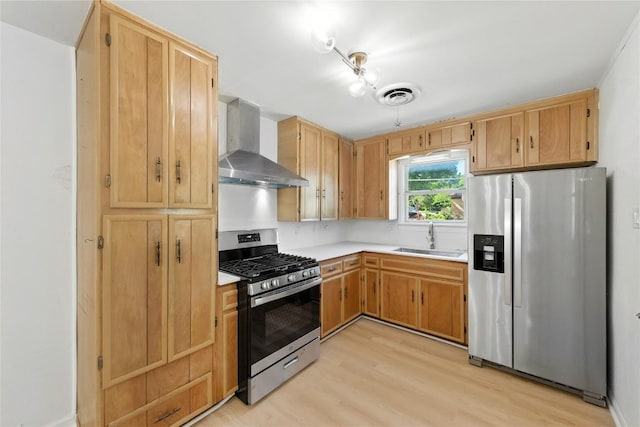 1302 S 2nd St, Killeen, TX 76541 - kitchen featuring appliances with stainless steel finishes, wall chimney range hood, light wood-style floors, and light countertops