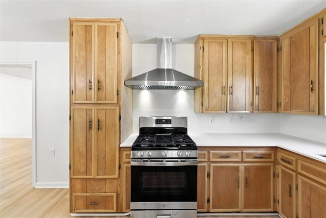 1302 S 2nd St, Killeen, TX 76541 - kitchen with wall chimney range hood, stainless steel gas stove, light countertops, and light wood finished floors