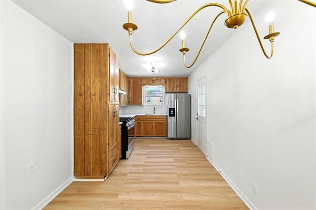 1302 S 2nd St, Killeen, TX 76541 - kitchen featuring appliances with stainless steel finishes, brown cabinetry, light wood-type flooring, light countertops, and extractor fan