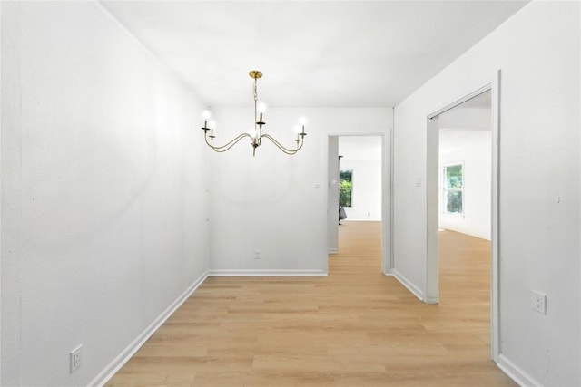 1302 S 2nd St, Killeen, TX 76541 - unfurnished dining area with a chandelier and light wood-style floors