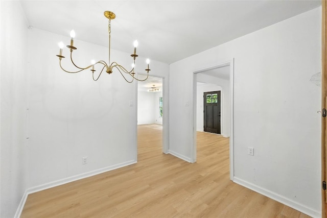 1302 S 2nd St, Killeen, TX 76541 - unfurnished dining area with a chandelier and light wood-type flooring