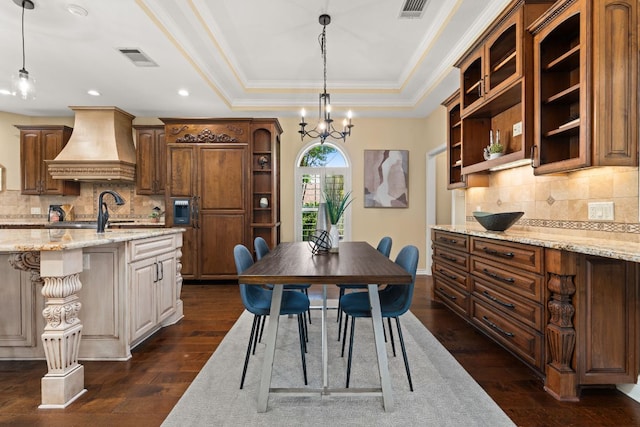 4206 River Place Blvd, Austin, TX 78730 - dining area featuring dark wood-type flooring, a chandelier, ornamental molding, a tray ceiling, and recessed lighting