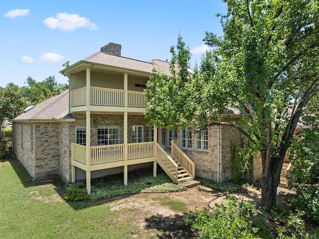 4206 River Place Blvd, Austin, TX 78730 - rear view of house with a chimney, brick siding, a balcony, and a yard