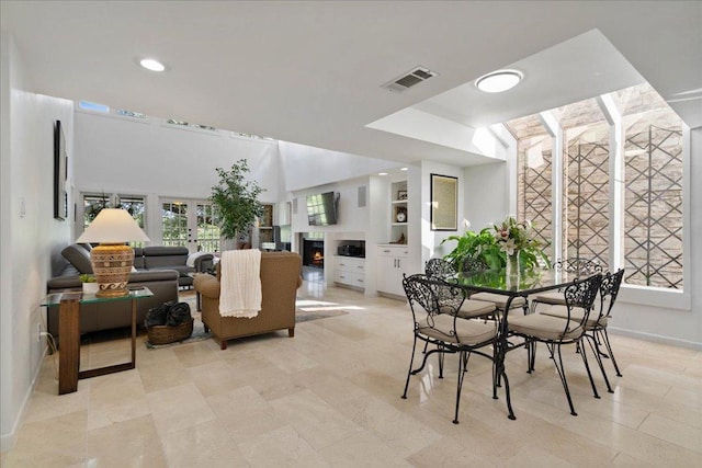 110 W Eagle Dr, The Hills, TX 78738 - dining space featuring a lit fireplace and recessed lighting