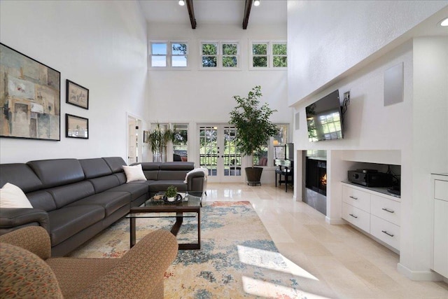 110 W Eagle Dr, The Hills, TX 78738 - living area featuring a high ceiling, french doors, a warm lit fireplace, and beamed ceiling