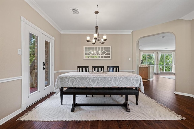 2743 Grimes Ranch Rd, Austin, TX 78732 - dining room with arched walkways, wood finished floors, a chandelier, and ornamental molding
