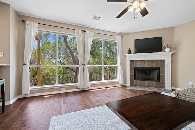 2743 Grimes Ranch Rd, Austin, TX 78732 - living area with a tile fireplace, ceiling fan, and wood finished floors