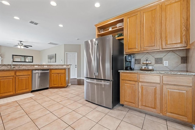 2743 Grimes Ranch Rd, Austin, TX 78732 - kitchen featuring appliances with stainless steel finishes, tasteful backsplash, ceiling fan, light tile patterned floors, and recessed lighting