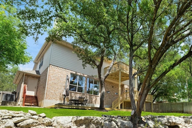 2743 Grimes Ranch Rd, Austin, TX 78732 - rear view of house with stairs, brick siding, and a balcony