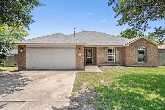1503 Sherry Dr, Taylor, TX 76574 - single story home with a garage, brick siding, driveway, and roof with shingles