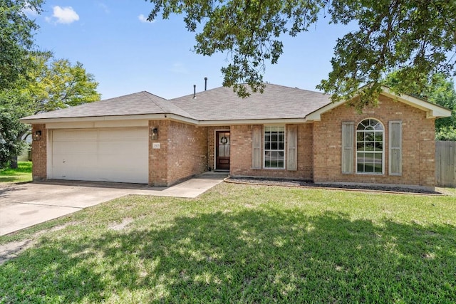 1503 Sherry Dr, Taylor, TX 76574 - ranch-style house with an attached garage, brick siding, concrete driveway, and a shingled roof