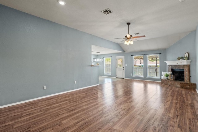 1503 Sherry Dr, Taylor, TX 76574 - unfurnished living room featuring lofted ceiling, wood finished floors, a fireplace, and ceiling fan