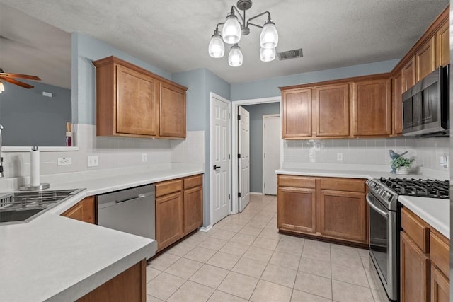 1503 Sherry Dr, Taylor, TX 76574 - kitchen with stainless steel appliances, tasteful backsplash, a ceiling fan, and light tile patterned flooring