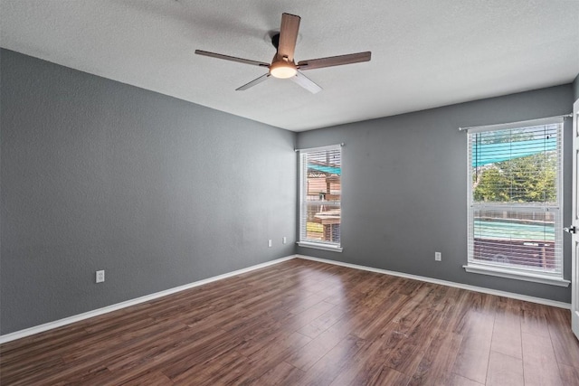 1503 Sherry Dr, Taylor, TX 76574 - unfurnished room with dark wood-style flooring, ceiling fan, a textured wall, and a textured ceiling